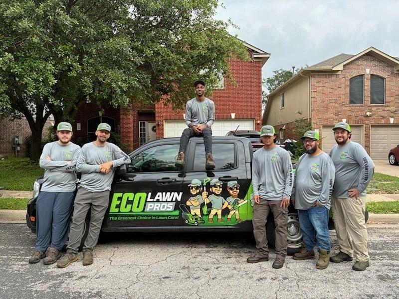 The Eco Lawn Pros crew standing with the branded truck in Round Rock