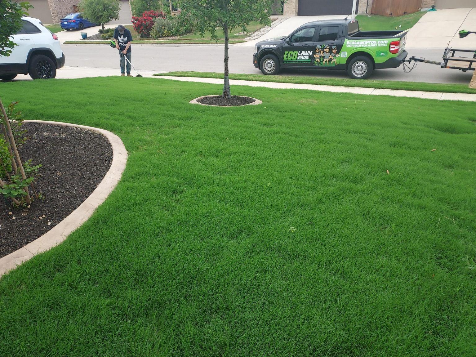 Eco Lawn Pros crew mowing a healthy green lawn in Round Rock, TX